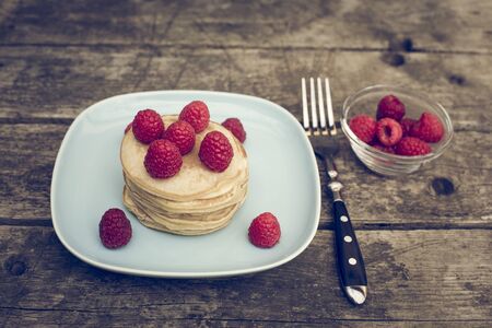 Pancakes with raspberries on plateの写真素材