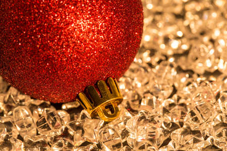Red Christmas bauble on silver starsの写真素材