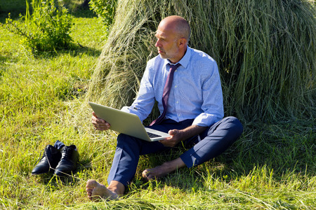 Germany, Bavaria, businessman working with laptop outdoorの写真素材