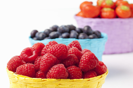 Forest berries, raspberries, blueberries and strawberries in baskets