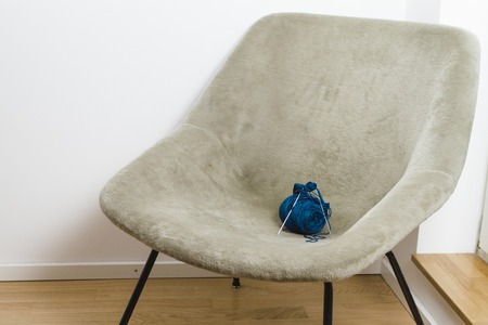 Armchair and blue knitting wool with needlesの写真素材