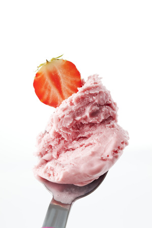 Strawberry ice cream portioning with spoonの写真素材