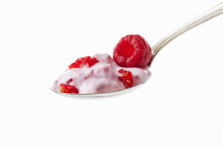 Spoon with raspberry yogurt and raspberryの写真素材