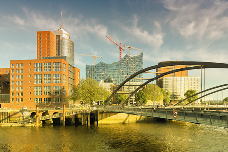 view on the Niederbaumbridge and Kehrwiederspitze, HTC and landmark Elbphilharmonie in Hamburg,...