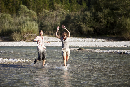 Couple having fun in riverの写真素材