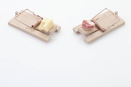 Pieces of cheese and ham on mousetrapの写真素材