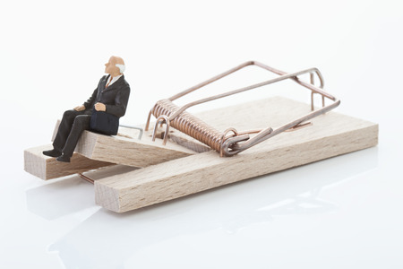 Figurine of man pensioner on mouse trap