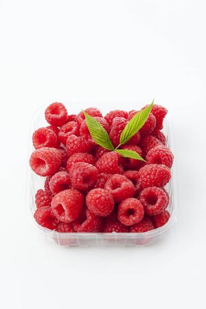 Raspberries in plastic bowl