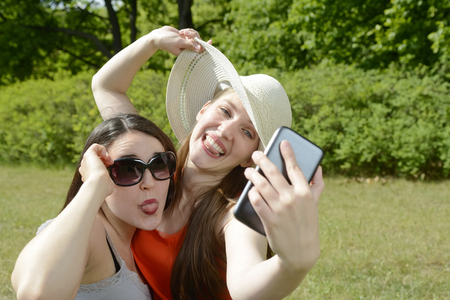 Girlfriends with smartphone, Selfieの写真素材