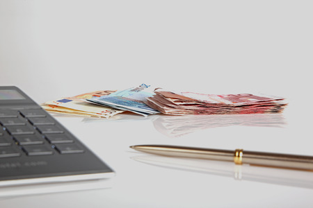 Euro banknotes, calculator and ballpenの写真素材