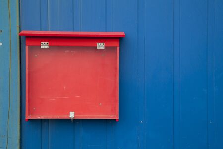 Red showcase on blue wooden wall