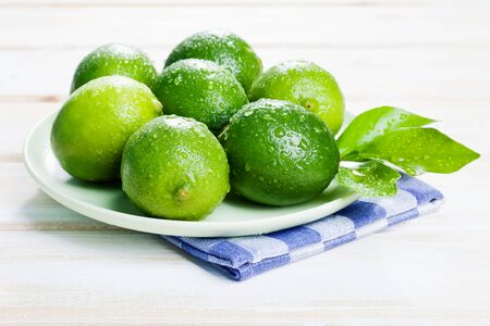 Plate of limes on napkin,close upの写真素材