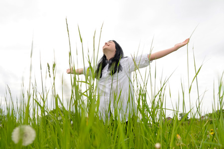 Young happy woman on meadowの写真素材