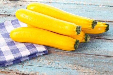Close up of yellow zucchini on checked napkinの写真素材