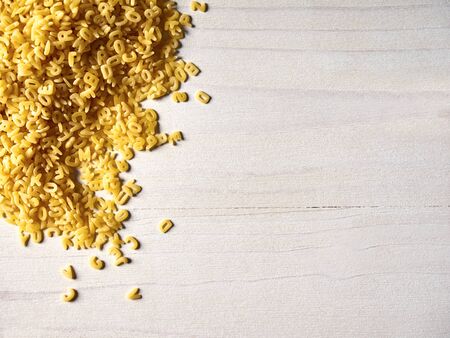 Alphabet noodles on wood, copy spaceの写真素材