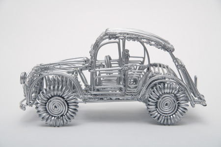 Toy car made of pliable wire against white background,close upの写真素材