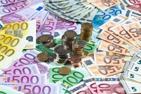 Various euro notes and coins as backgroundの写真素材