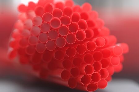 Bunch of red drinking straws, close up.の写真素材