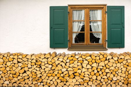 Window and stack of woodの写真素材