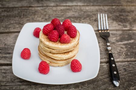 Pancakes with raspberries on plateの写真素材
