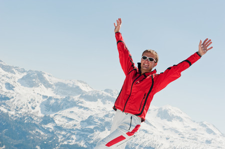 Austria,Salzburg Country,Mid adult man stretching hands in winterの写真素材