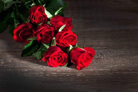 Red roses, wooden backgroundの写真素材