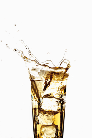 Glass of apple spritzer with ice cubes, close-upの写真素材
