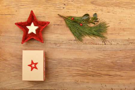Christmas present, fir twig and red bowl on woodの写真素材