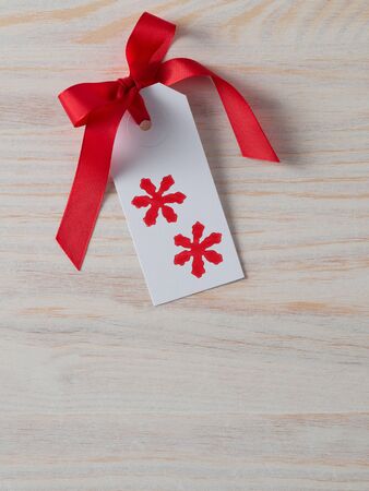 Christmas, gift tag, printed, red ribbon, background woodの写真素材