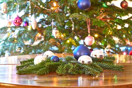 Christmas, baubles and evergreens on table, Christmas treeの写真素材