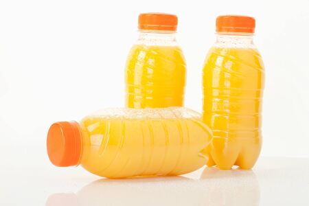 Orange juice bottles on white background,close upの写真素材