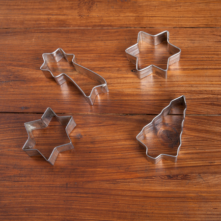 Biscuit cutter for christmas cookies on woodの写真素材
