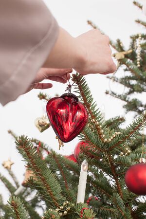 adult woman positioning christmas ornamentの写真素材