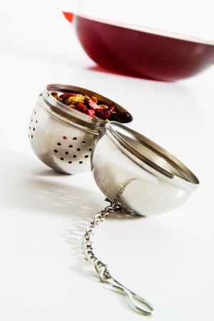 Teapot, tea strainer, fruit tea, white backgroundの写真素材