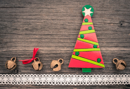 Christmas decoration of wood, bells and lace on woodの写真素材