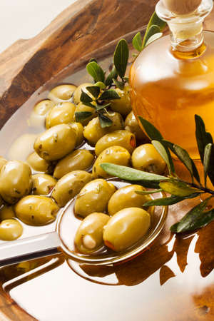 Filled green olives in oil, spoonの写真素材