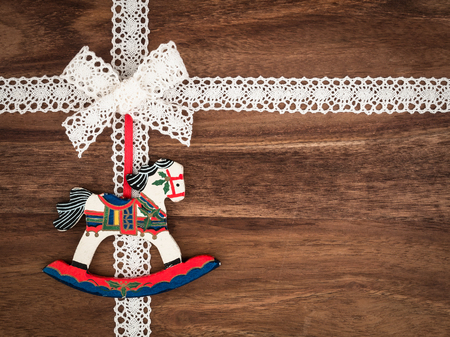 Christmas, lace, present, christmas decoration rocking horse on woodの写真素材