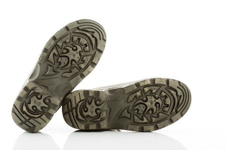 Soles of winter boots against white backgroundの写真素材