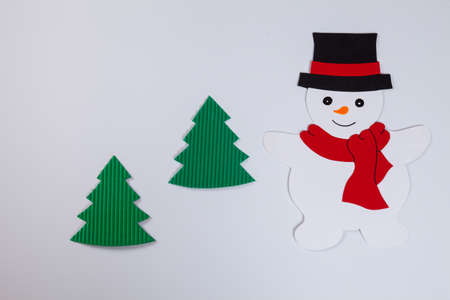 Snowman and fir trees, white backgroundの写真素材