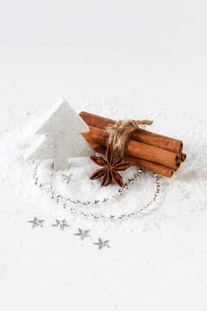 Christmas arrangement, cinnamon sticks and white decorationの写真素材