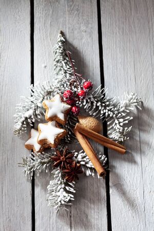 Fir twig with cinnamon stars rose hips cinnamon sticks almondの写真素材