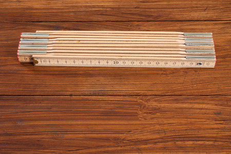 Folding rule on woodの写真素材