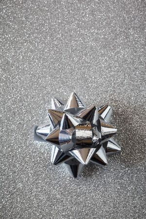 Silver bow on shiny underground, copy spaceの写真素材