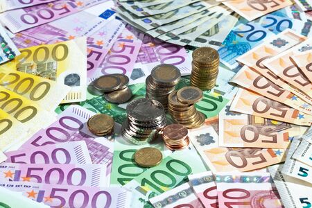 Various euro notes and coins as backgroundの写真素材
