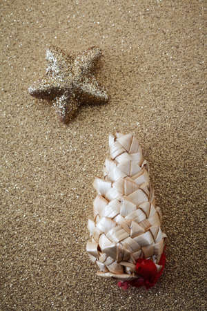 Straw cone and star on golden shiny undergroundの写真素材