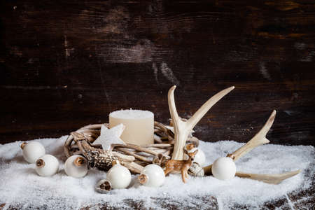 Christmas decoration, wreath with white candle, baubles, antlerの写真素材