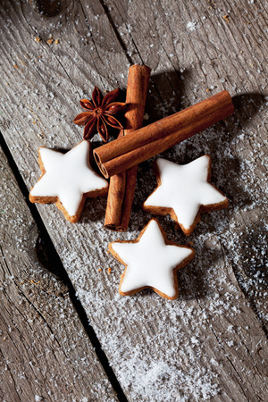 Cinnamon stars with spices on wooden backgroundの写真素材