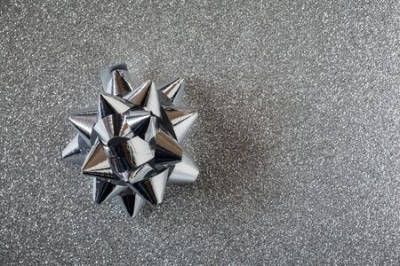 Silver bow on shiny underground, copy spaceの写真素材