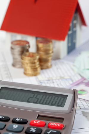 Model house calculator euro notes and coins on blueprint, planning constructionの写真素材