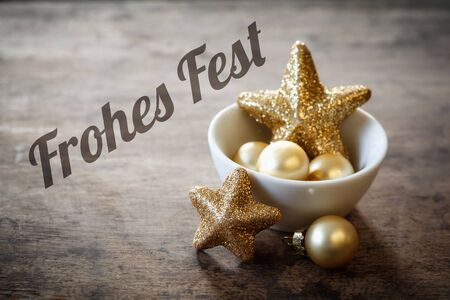 Christmas decorations in bowl, German wishes, Frohes Festの写真素材